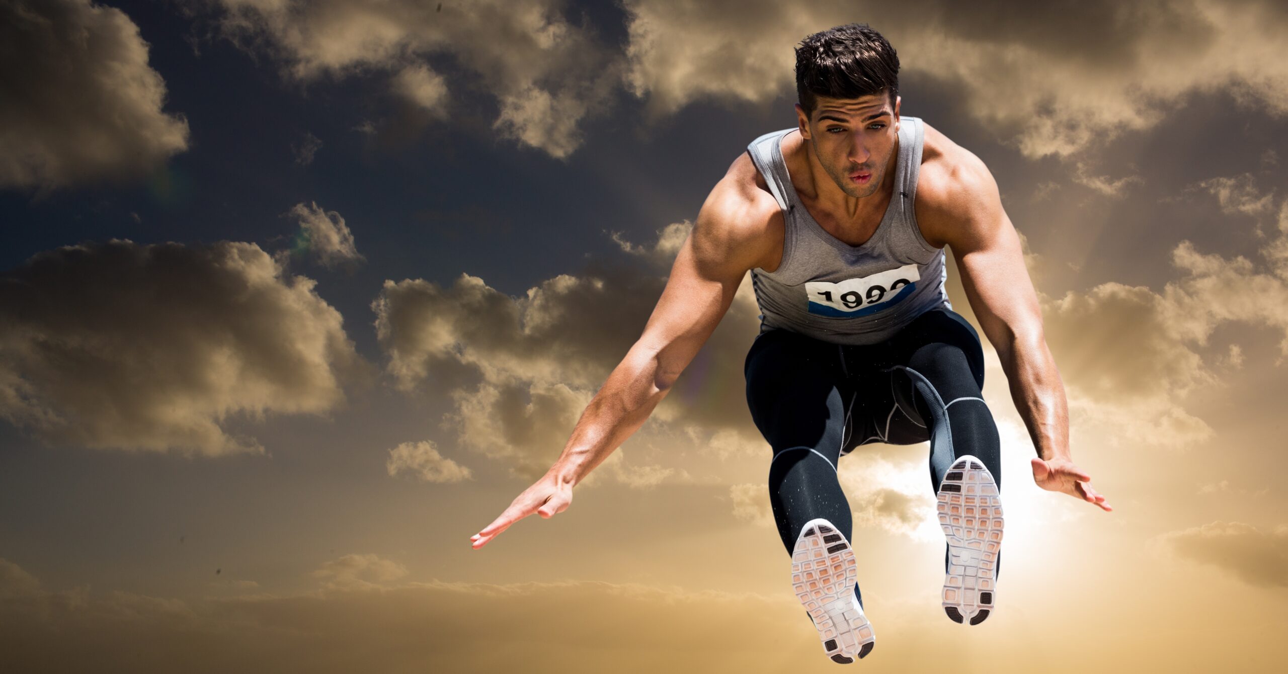 Athlete practicing high jump against sky in background