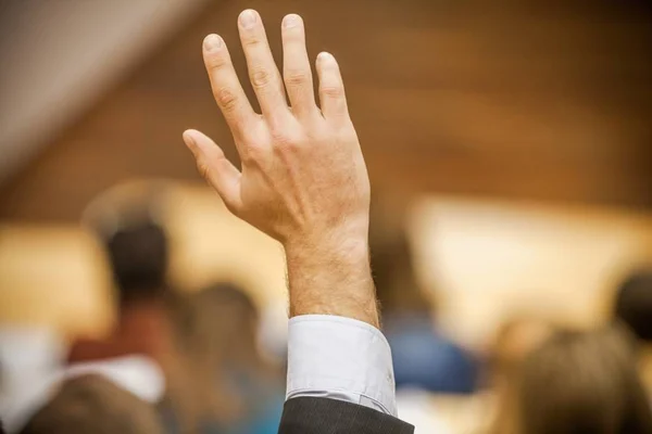 depositphotos_207500354-stock-photo-closeup-of-a-raised-hand