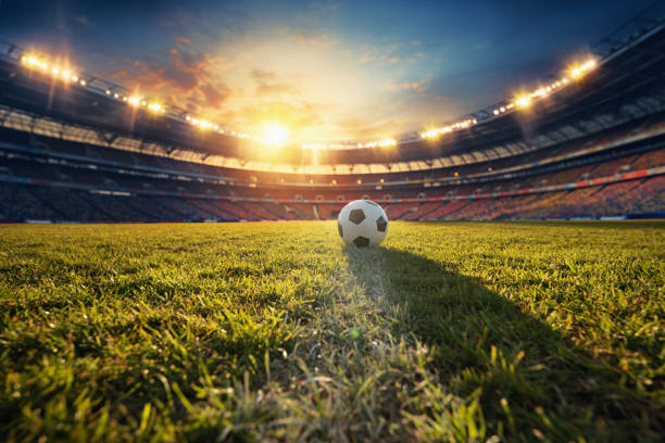 ball on the green field in soccer stadium. ready for game in the midfield